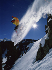 Airborne Snowboarder with Sunburst