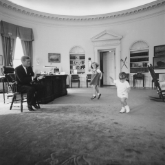 Caroline and John Jr. Dance in the Oval Office as President Kennedy Claps. 1962
