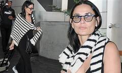 Demi Moore cuts a casual look in long black dress while arriving ...