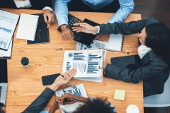 Business people working together in office Top view of business people using laptop and documents