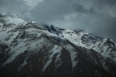 A Snow Covered Mountain under a Gloomy Sky · Stock Photo