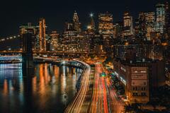 Brooklyn Bridge Against Skyscrapers at Night · Stock Photo