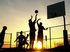 Students Play a Basketball Game as the Sun Sets at Bucks County Community College